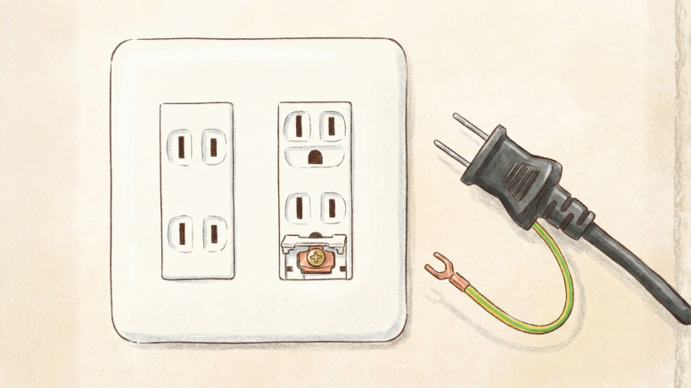 壁のコンセントのアース端子に、緑と黄色の保護被膜が付いたアース線を接続しようとしている様子。